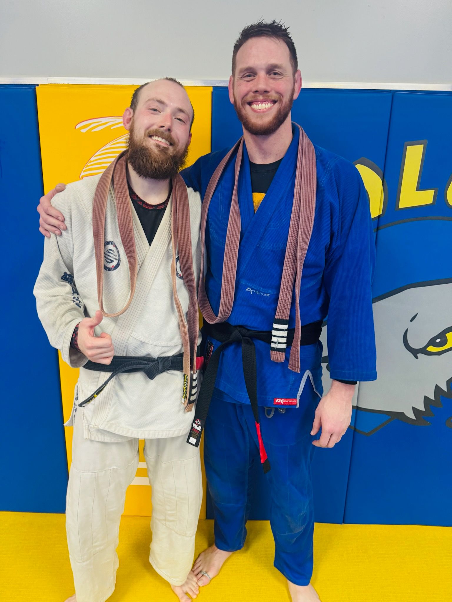 Young men in gi with medals after Brazilian Jiu-Jitsu competition at Absolute Jiu-Jitsu Academy.