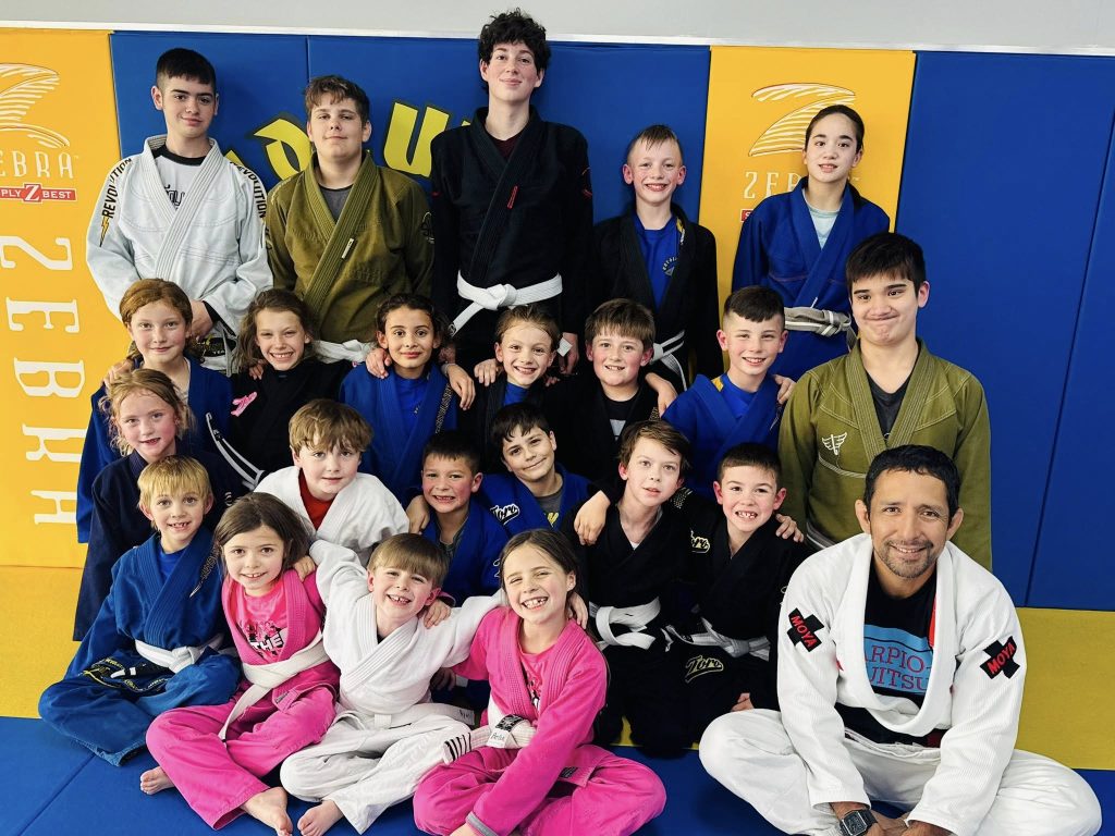 Kids in gi uniforms smiling after Brazilian Jiu-Jitsu training at Absolute Jiu-Jitsu Academy.