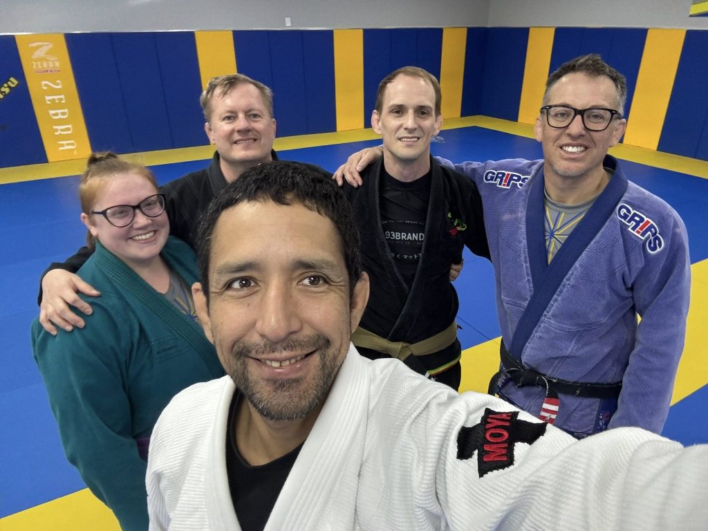 Selfie of BJJ students and instructors at Absolute Jiu-Jitsu Academy, showcasing Brazilian Jiu-Jitsu training and community.