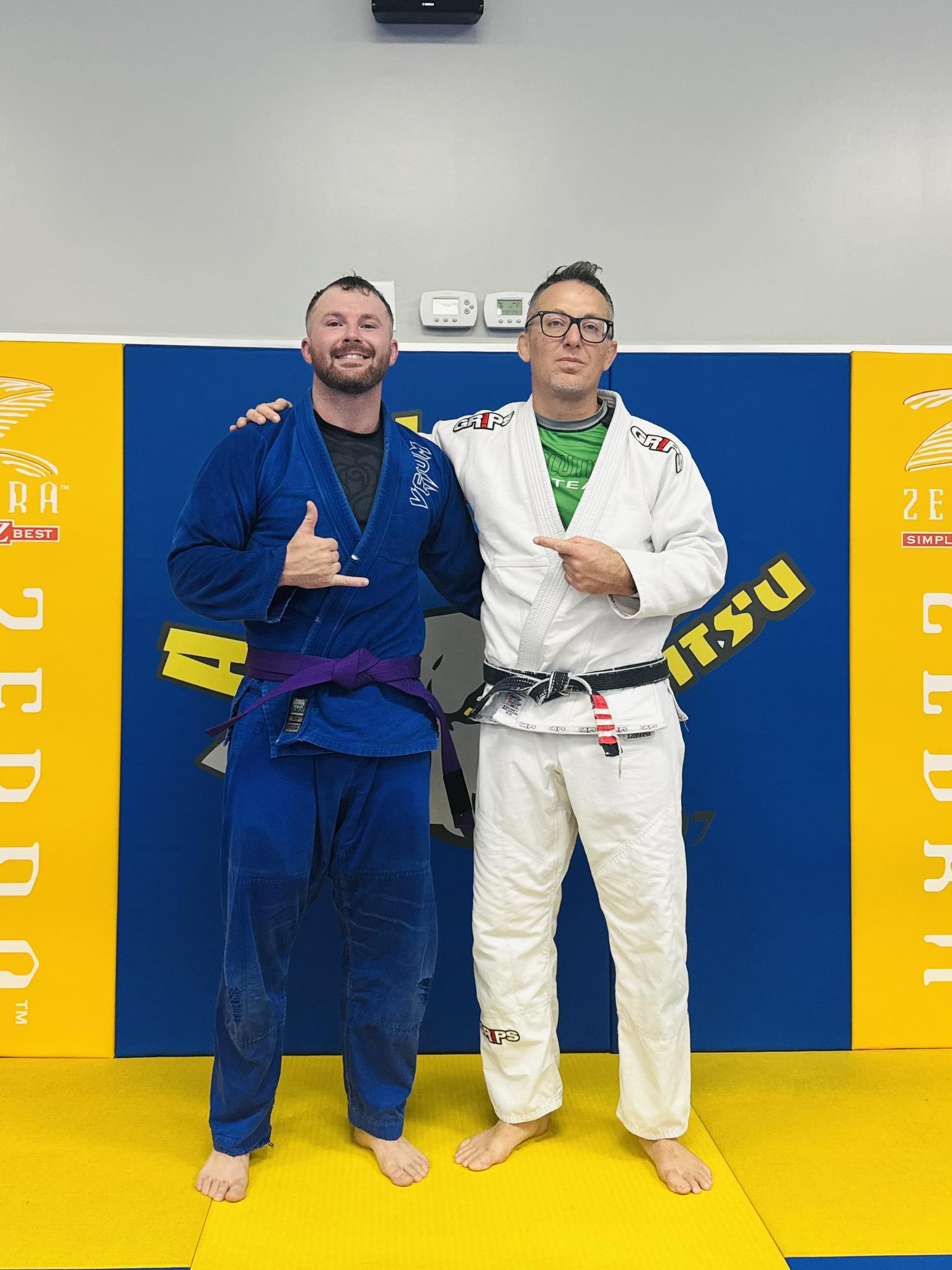 Brazilian Jiu-Jitsu black belt with an orange belt on another student at Absolute Jiu-Jitsu.